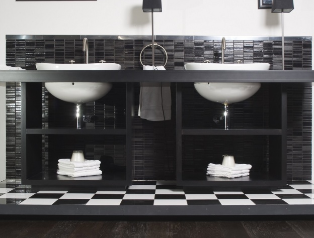 Lifestyle image of a black and white bathroom with double washbasin units